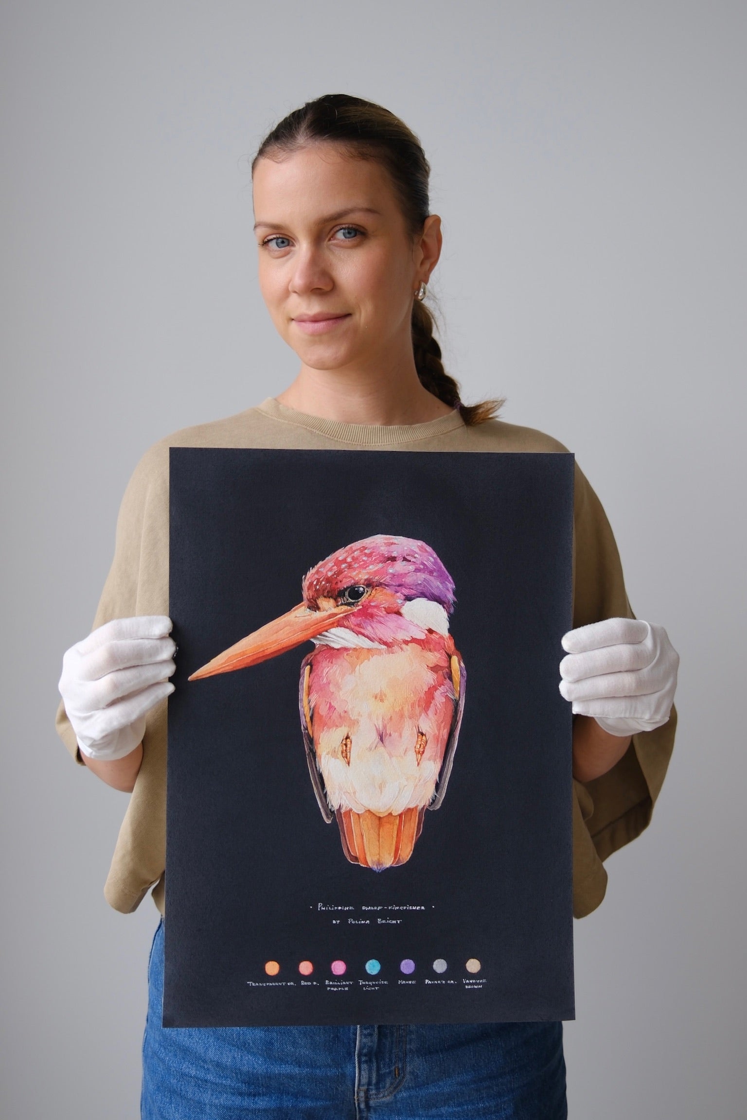 Polina Bright holding the original Philippine Dwarf Kingfisher painting